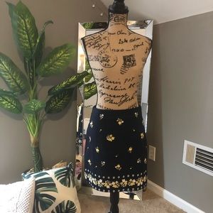 Navy blue skirt with embroidered flowers.